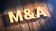 Fat gold letters "M & A" sitting on a wooden background [Image by creator Tim from AdobeStock]